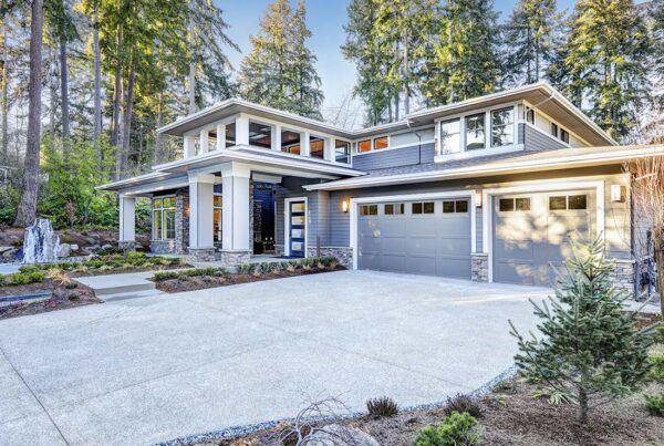 High Net Worth Insurance - Luxurious New Construction of Home With Lots of Windows in a Scenic Wooded Area and Large Driveway