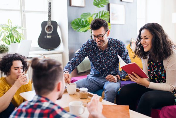 Off-Campus Student Housing Insurance - A Group of Young College Friends in the Living Room at Their Off-Campus Home