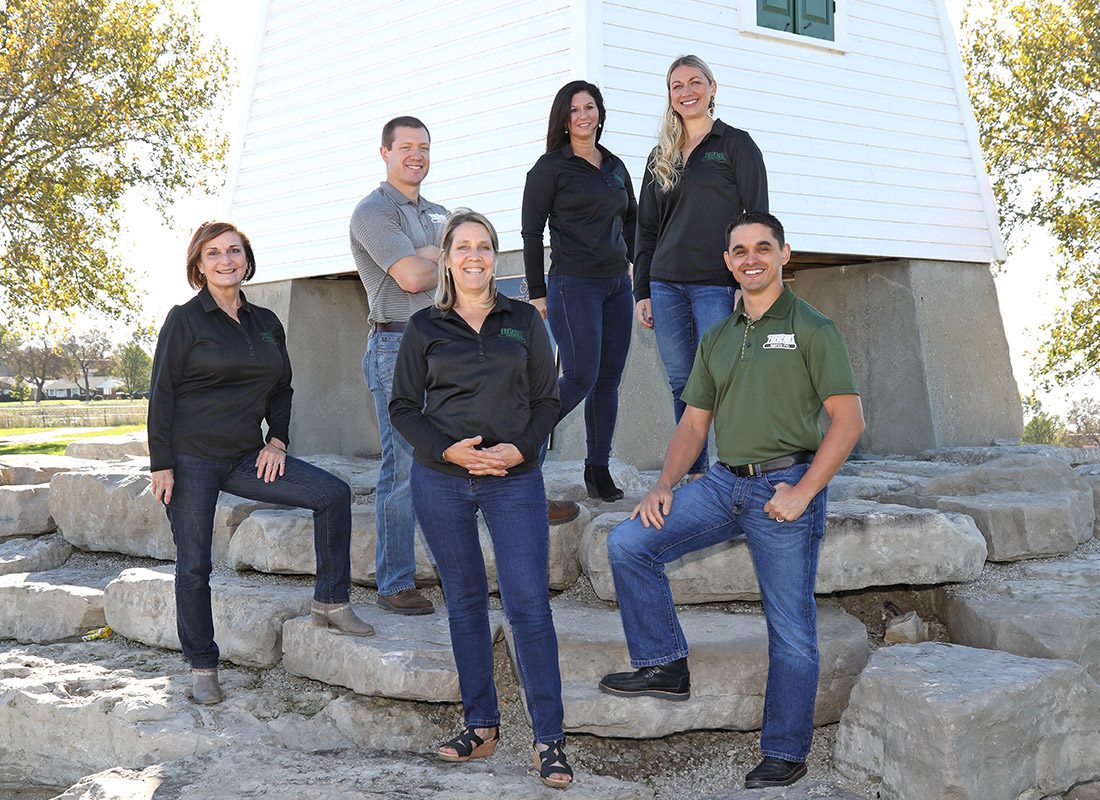 About Our Agency - Frederick Agency Inc. Team Standing at the Bottom of the Port Clinton Lighthouse